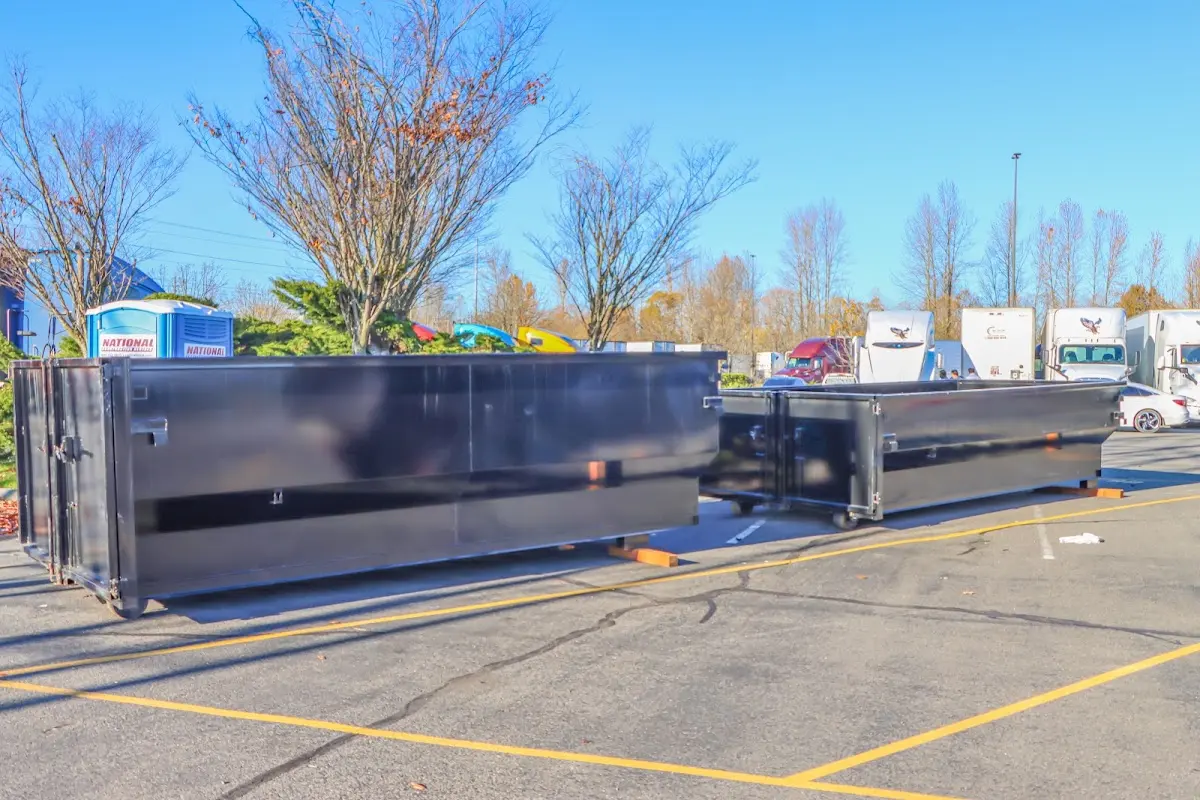 Professional dumpster rental service with roll-off container on residential driveway in Texas City